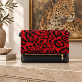 Red Leopard clutch with a leopard painting in the background